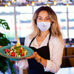 Happy waitress working at a restaurant COVID  19 Concept